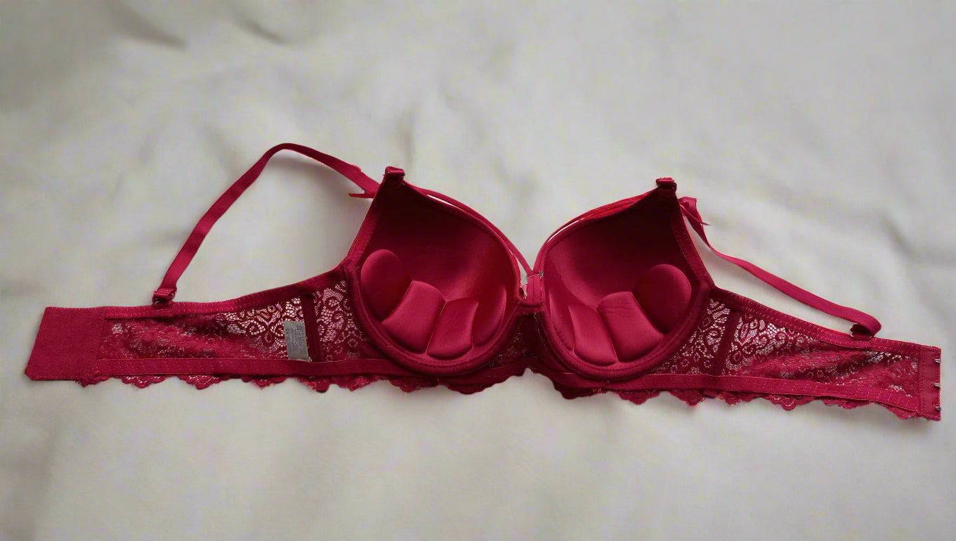 Red bra on a white bedspread